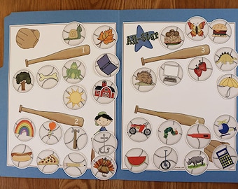 May include: A blue folder with a white background and a baseball theme. The folder has four baseball bats with numbers 1 through 4. The folder has a variety of images on it, including a snail, a leaf, a butterfly, a hamburger, a dinosaur, a computer, strawberries, an umbrella, a tree, a bone, a frog, a book, a hedgehog, a sun, a barn, a car, a caterpillar, a thermometer, a helicopter, a hot dog, a pizza, a pencil, a turkey, a watermelon, a unicycle, a rhinoceros, and a calculator.