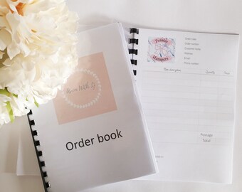 Puede incluir: Un libro de pedidos blanco con un logotipo rosa que dice "Avon With Ly" y las palabras "Order book" en texto negro. El libro está abierto en una página con un logotipo rosa y azul que dice "Twinkle Hampers" y una sección para los detalles del pedido.