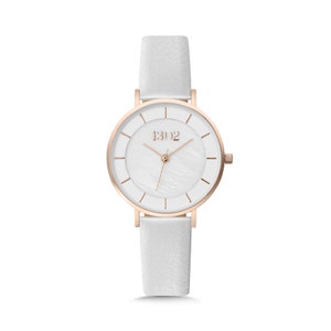 May include: A white wristwatch with a rose gold case and white leather band. The watch face has a white mother-of-pearl dial with rose gold hands and hour markers. The watch face also has the text "1302" printed on it.