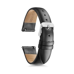 May include: A black leather watch strap featuring a silver-toned metal buckle with the engraving 1302. The strap has a smooth exterior finish, a light tan underside embossed with the word LEATHER, and integrated spring bars for attachment.