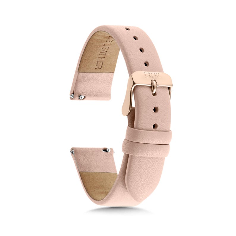 May include: A light pink leather watch strap featuring a rose gold-toned metal buckle with the engraved text 1312. The strap includes a series of adjustment holes, two leather loops, and silver-toned spring bar pins at the attachment ends.