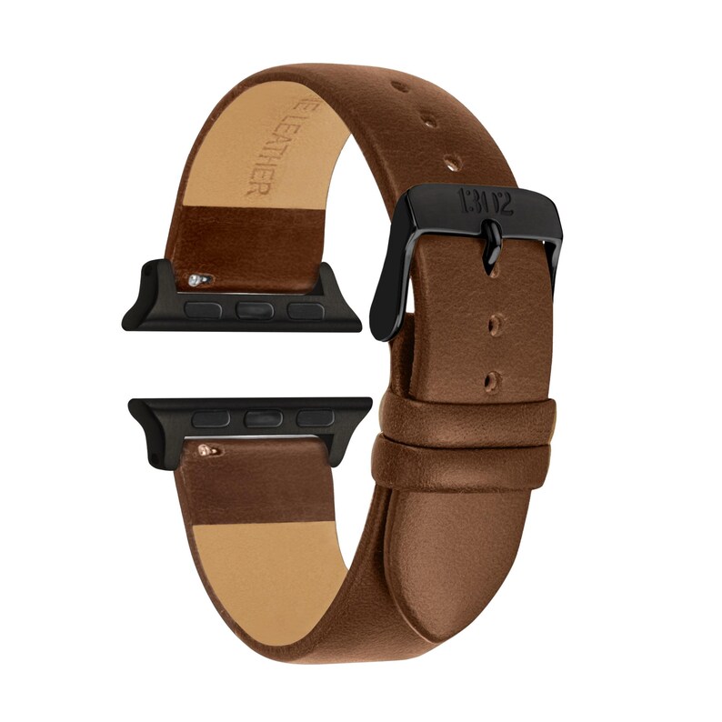 May include: A brown leather watch band featuring black metal connectors and a black buckle. The strap has a smooth finish with visible stitching holes and the text GENUINE LEATHER embossed on the inner side. The buckle is engraved with the text 13102.
