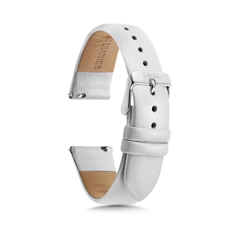 May include: A white leather watch strap featuring a silver-toned metal buckle and a series of adjustment holes. The interior of the strap is lined with a tan material and includes the embossed text GENUINE LEATHER, while the buckle is engraved 131Y2.
