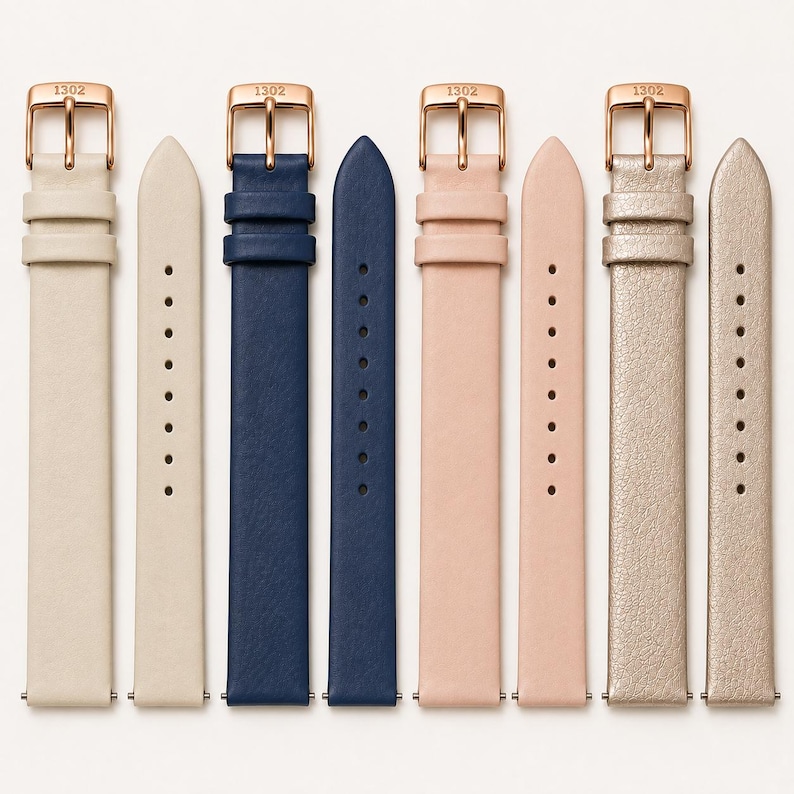 May include: Four pairs of watch straps in cream, navy blue, light pink, and metallic gold. Each strap features a rose gold-toned buckle engraved with the text 1302. The straps have two loops and a series of adjustment holes for a secure fit.