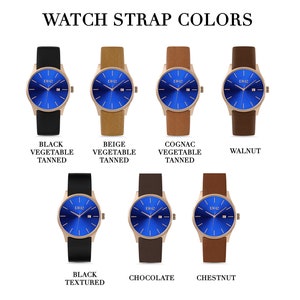 K&ouml;nnte beinhalten: Eine Uhr mit blauem Zifferblatt und verschiedenen Armbandfarben, darunter Schwarz, Beige, Cognac, Nussbaum, Schokolade und Kastanie.