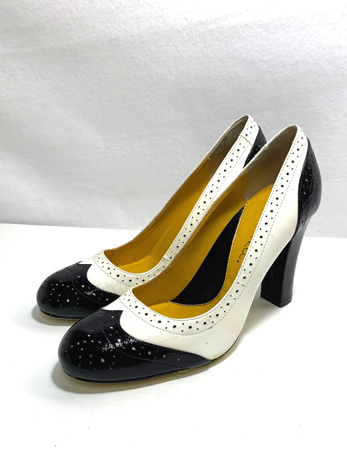 black and white wing tip heels