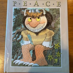 May include: A children's book titled "THE BIG BOOK FOR PEACE" features a whimsical illustration of a monster-like creature with yellow eyes, horns, and a nest of birds on its head. The creature is in a forest setting, with the book's title prominently displayed.