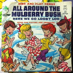 May include: A vintage record featuring a colorful illustration of children playing around a mulberry bush. The record is titled "All Around the Mulberry Bush" and includes the lyrics "Here We Go Looby Loo". The record is by Peter Pan Players and Orchestra.