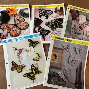May include: A collection of home decor patterns featuring butterfly designs. The patterns include a kitchen set, butterfly set, tissue box, fridge magnets, and plaques. The patterns are on white paper with yellow accents.