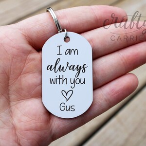 May include: White metal keychain with the text "I am always with you" and a heart with the name "Gus" below it.