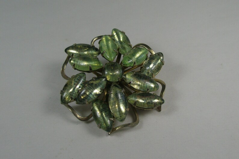 Interesting green stoned snowflake brooch