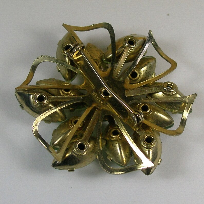 Interesting green stoned snowflake brooch