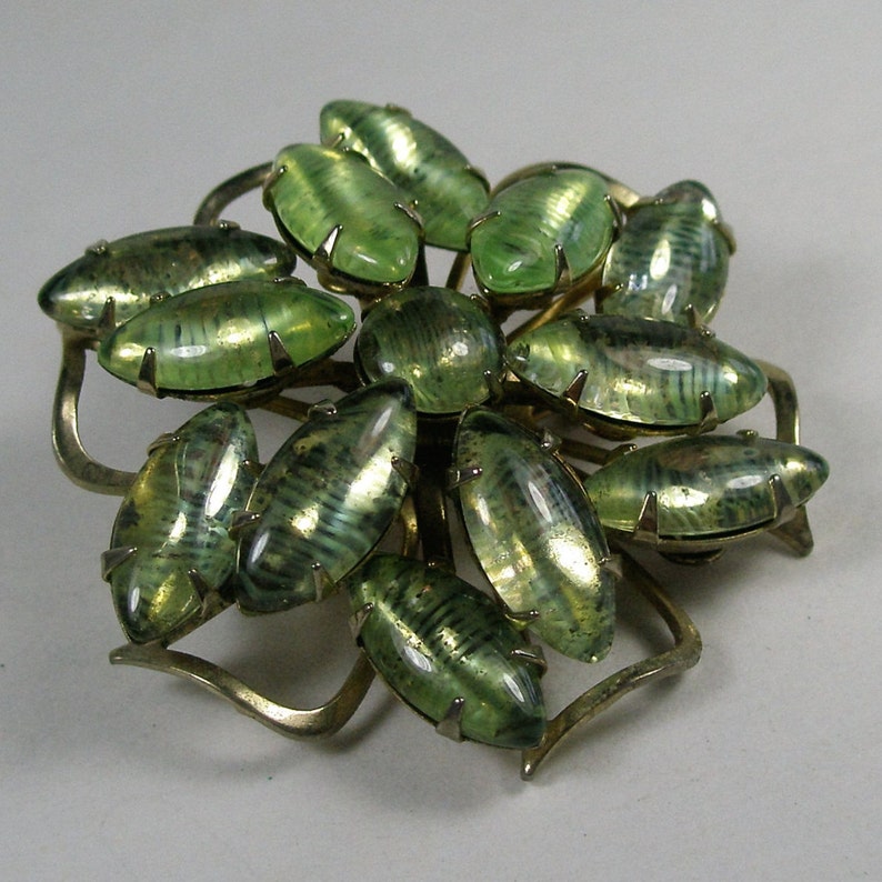 Interesting green stoned snowflake brooch