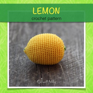 May include: A crocheted lemon, yellow with green accents, on a wooden surface. The image includes the text "LEMON crochet pattern".