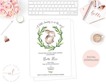 May include: A baby shower invitation with a watercolor illustration of a bunny in a green wreath. The text reads "A little bunny is on the way!" and includes space for the baby's name, date, time, location, and RSVP information. The invitation is a digital download.