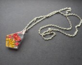Vintage reverse carved lucite pendant with dark pink flowers