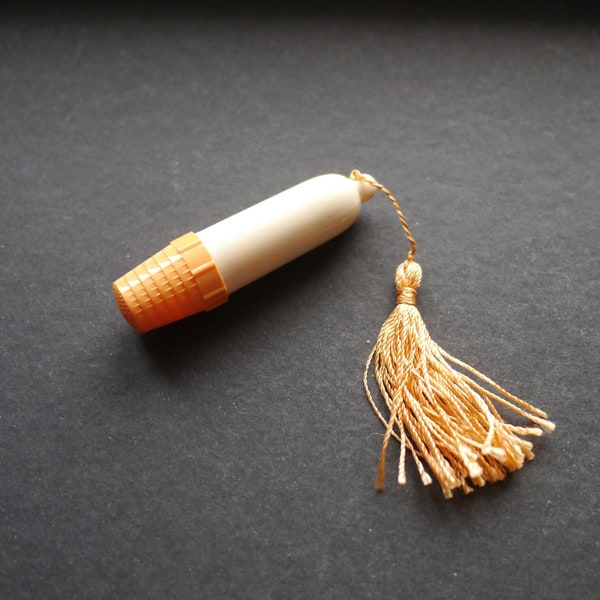 Little plastic needle case etui with thimble, cream and orange with tassel