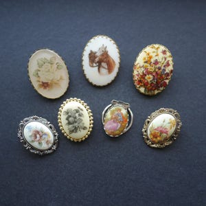 Lot of seven printed scarf clips various designs