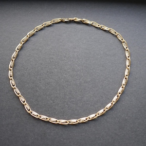 Gold tone chain necklace with clear rhinestones
