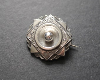 Victorian white metal engraved target brooch