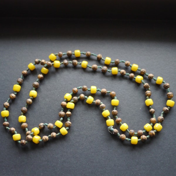 Long single strand necklace yellow glass and brown wood beads on green thick knotted thread