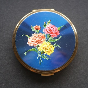 Vintage gold tone and blue enamel compact with carnations