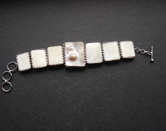 Silver tone chain linked bracelet with mother of pearl pieces