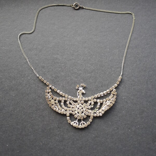Silver tone metal chain necklace with small clear rhinestones, peacock bird, some missing stones