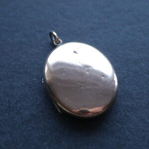 Vintage gold tone metal double photo locket