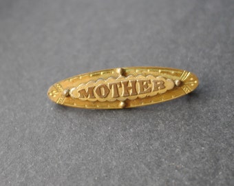 Edwardian gold tone metal Mother bar brooch, signed TSC