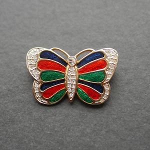 Butterfly brooch, gold tone metal with red green and blue enamel, clear rhinestones