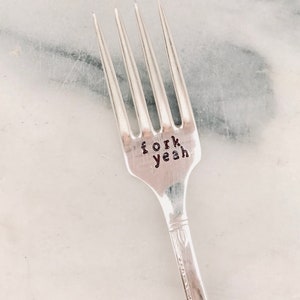 May include: A silver fork with the words "fork yeah" engraved on the handle.