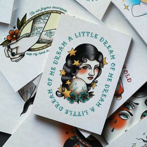 a collage of various tattoo designs, including a prominent illustration of a woman's face with a floral design and stars around it.