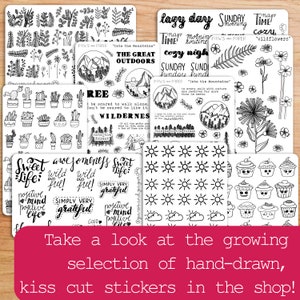 May include: A collection of black and white hand-drawn sticker sheets featuring various designs, including nature, plants, animals, and inspirational quotes. The sticker sheets are labeled with the text "PAWS and PAPER" and "Into the Mountains".