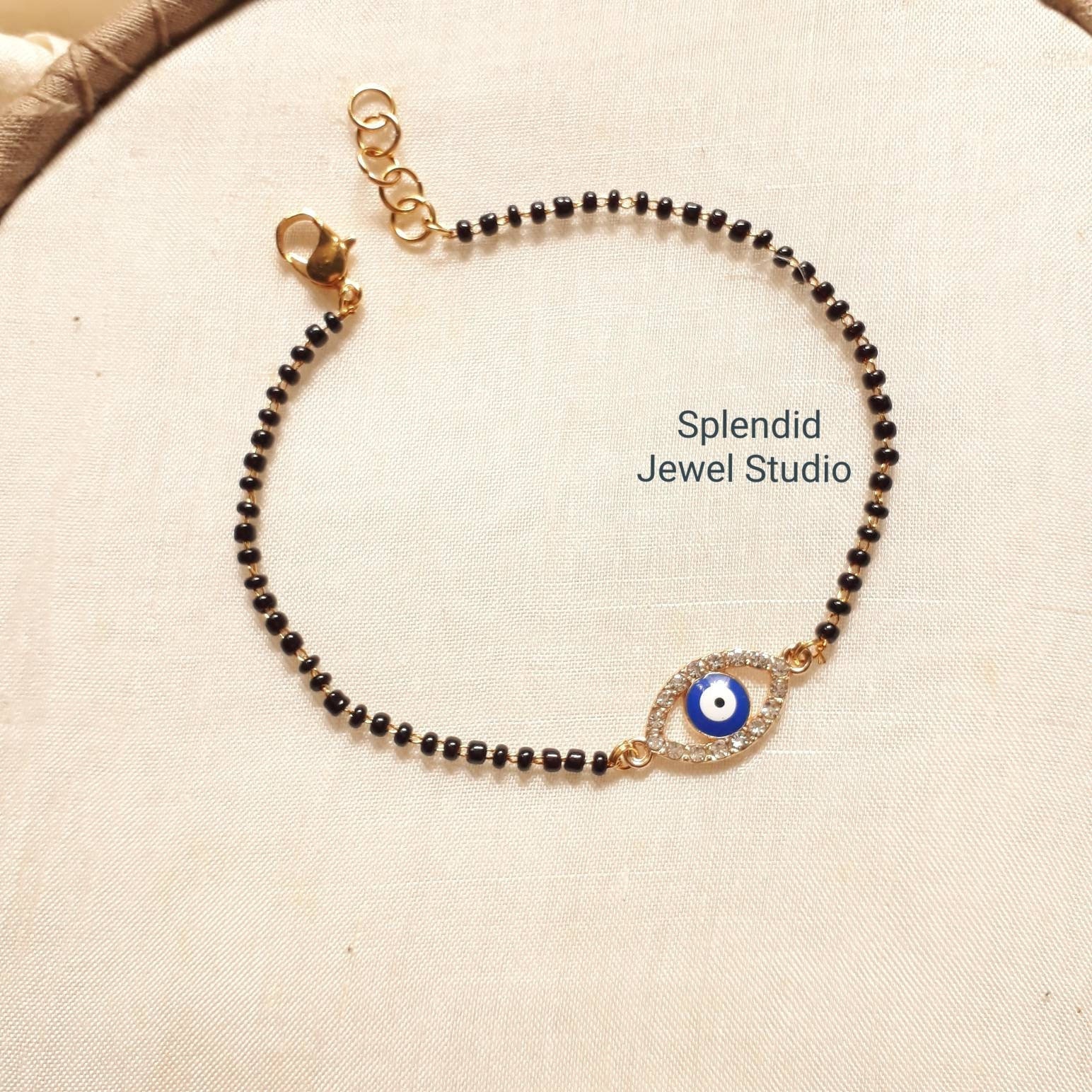 bracelet mangalsutra | Black beaded jewelry, Black beaded bracelets, Gold  jewelry stores