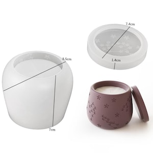 May include: A white, round candle holder with a diameter of 8.5 cm and a height of 7 cm. A separate lid is shown with a diameter of 7.4 cm and a thickness of 1.4 cm. A purple candle holder with a lid is also shown.