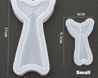 May include: Two silicone molds for making mermaid tail shapes. The larger mold is 9.8 inches wide and 17 inches tall. The smaller mold is 6 inches wide and 9.7 inches tall. Both molds have a detailed mermaid tail design.