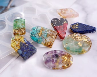 May include: Assortment of colorful resin pendants with gold flakes and various stones, including green, blue, red, purple, and pink. The pendants are in different shapes, including heart, oval, and rectangle.
