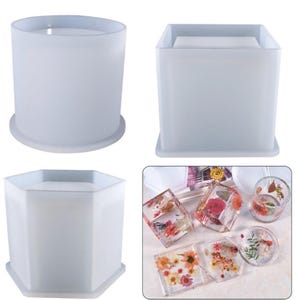 May include: Three silicone moulds for resin casting. The moulds are a round cylinder, a square, and a hexagon. The moulds are shown with finished resin castings of various shapes and sizes.