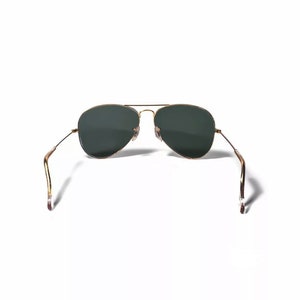 May include: Gold aviator sunglasses with dark green lenses. The sunglasses are folded in half with the arms pointing upwards.