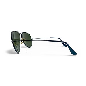 May include: Black aviator sunglasses with green lenses. The sunglasses have a double bridge and thin temples. The lenses are a teardrop shape. The frame is black and the temples curve at the ends.