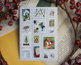May include: A sheet of vintage-style Christmas stickers with a blue background and white borders. The stickers feature various winter scenes, including a snow-covered village, a gingerbread house, a snow globe with a Christmas tree, a rocking horse, and a letter to Santa.