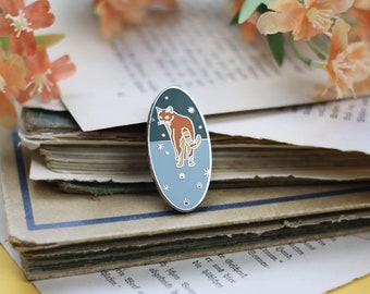 May include: A silver enamel pin featuring a red panda standing on a blue and green background with white stars. The pin is oval shaped and has a shiny finish.