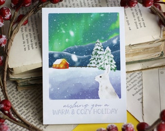 Postcard - bunny in the snow - northern lights - mountain landscape with hut - warm and cozy holiday - Christmas winter - own illustration