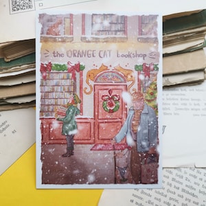 Carte postale - Librairie sous la neige - Noël - Librairie chat orange - Aquarelle - Cosy - Chien - Chat - Livres - Illustration personnelle