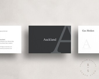 May include: A black and white business card with the text "Auckland" and a stylized letter "A" in gray. The back of the card has the text "Gus Holden" and a stylized letter "A" in gray. The card also has the text "Premium Designs" and "Ruben Sto" in a circle.