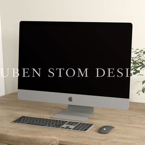 May include: A silver iMac computer with a black screen, a wireless keyboard, and a wireless mouse on a wooden desk. The text "RUBEN STOM DESIGN" is visible on the screen.