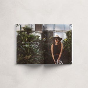 May include: A woman wearing a black tank top, a brown hat, and sunglasses stands in a greenhouse. The quote "You can do anything, but not everything." is printed on the page.