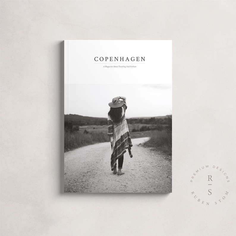 May include: Black and white photo of a woman wearing a hat and a patterned poncho walking down a dirt road. The image is for a magazine called "Copenhagen: A Magazine About Traveling and Fashion" with the logo "Premium Designs Ruben Storm" in a circle.