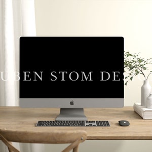 May include: A modern home office workspace with a silver iMac computer, a wireless keyboard, and a wireless mouse. A wooden desk with a light wood finish. A white book with a small plant in a white vase on top of the book.